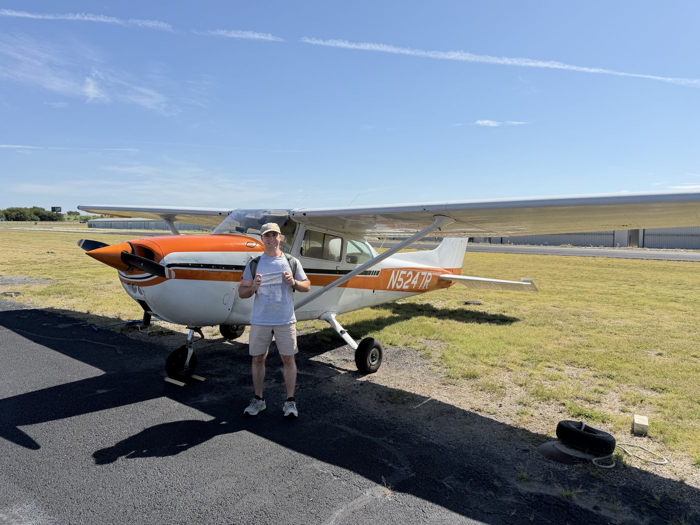 Student with his signed solo shirt in front of Cessna 172 N5247R